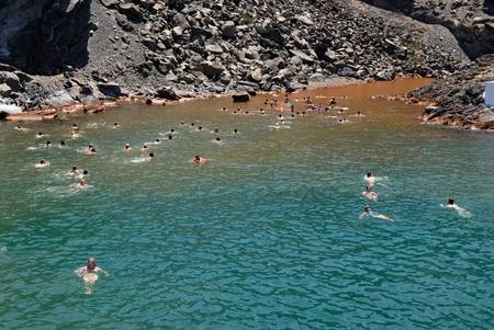 Tourists swimming in the sea at the volcanic island Palea Kameni in Greece. Photo taken at 12th of June 2008のeditorial素材