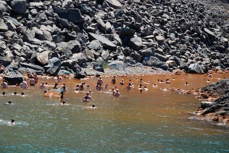People swimming in the hot springs at the island Palea Kameni near Santorini, Greece. Photo taken at 12th of June 2008のeditorial素材
