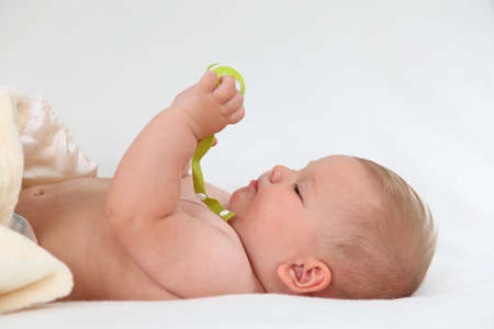 Cute baby girl playing in bed