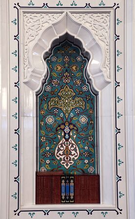 Oriental mosaic decoration in a mosque. Quran books in a shelf. Sultanate of Omanの写真素材