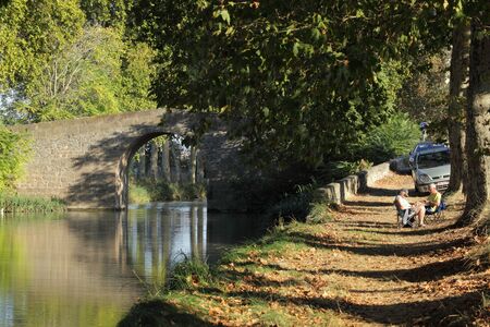 Retired couple relaxing at the Canal du Midi near Beziers, southern France. Photo taken at 2nd of October 2011のeditorial素材