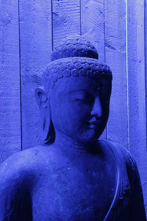 Blue illuminated buddha statueの写真素材