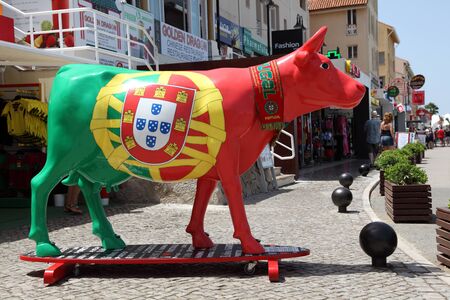 Cow on surfing board painted in national Portuguese colors. Vilamoura Marina, Algarve Portugalのeditorial素材