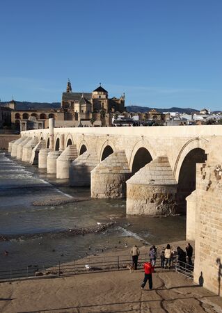 The Roman Bridge with the Cathedral-Mosque of Cordoba in the background. Andalusia, Spainのeditorial素材