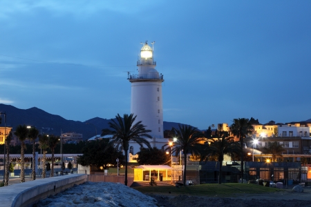 Lighthouse in Malaga illuminated at dusk, Andalusia Spainの写真素材