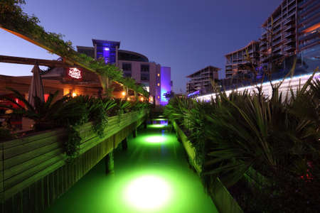 Green illuminated canal in Ocean Village Marina, Gibraltarのeditorial素材