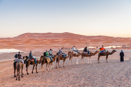 Camel caravan with tourists going to sahara desert in Morocco, Africaのeditorial素材