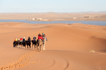 Camel caravan with tourists in the sahara desert. Morocco, Africaのeditorial素材