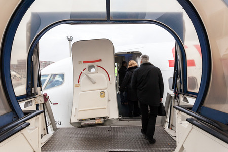 FRANKFURT - DEC 6: Boarding of an airplane at the Frankfurt International Airport. December 6, 2014 in Frankfurt Main, Germanyのeditorial素材