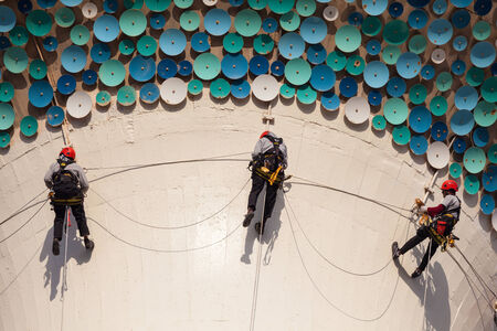 KUWAIT - DECEMBER 8: Workers hanging on ropes at the sphere of a Kuwait Tower. December 8, 2014 in Kuwait City, Middle Eastのeditorial素材