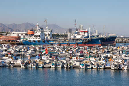 FUJAIRAH, UAE - DEC 14: Boats and ships in the fishing port of Kalba. December 14, 2014 in Fujairah, United Arab Emiratesのeditorial素材