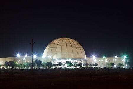 DUBAI, UAE - DEC 16: Dubai Outlet Mall illuminated at night. December 16, 2014 in Dubai, United Arab Emiratesのeditorial素材