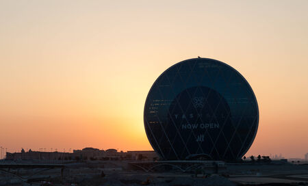 ABU DHABI - DEC 19: Aldar Headquarters circular building at sunset. December 19, 2014 in Abu Dhabi, United Arab Emiratesのeditorial素材
