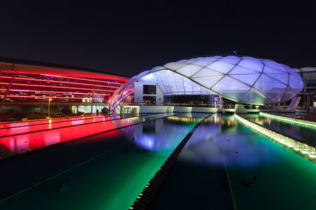 ABU DHABI - DEC 19: Ferrari World Theme Park illuminated at night. December 19, 2014 at the Yas Island in Abu Dhabi, UAEのeditorial素材