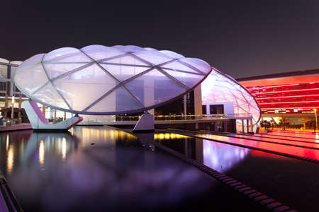 ABU DHABI - DEC 19: Ferrari World Theme Park illuminated at night. December 19, 2014 at the Yas Island in Abu Dhabi, UAEのeditorial素材