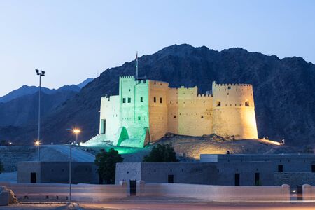 Historic fort of Fujairah illuminated at night. United Arab Emirates