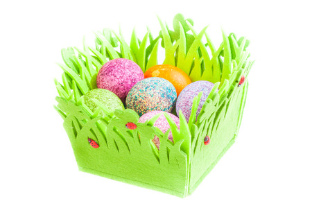 Easter eggs in a basket isolated over white