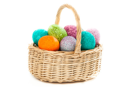 Easter eggs in a basket isolated over white