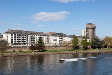 FRANKFURT MAIN, GERMANY - APR 18: View over the River Main and residential waterfront buildings in Frankfurt. April 18, 2015 in Frankfurt Main, Germanyのeditorial素材