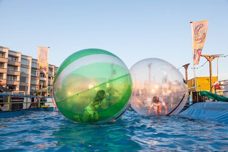 ZANDVOORT, NETHERLANDS - AUG 8: Children in soap bubbles floating on the water. Seaside promenade in Zandvoort. August 8, 2015 in Zandvoort, Netherlandsのeditorial素材