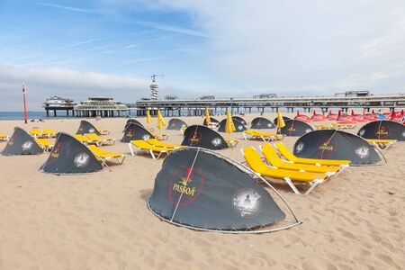 SCHEVENINGEN, NETHERLANDS - AUG 10: Windscreens and sunloungers on the beautiful North Sea beach in Scheveningen. August 10, 2015 in Scheveningen, The Netherlandsのeditorial素材