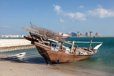 Traditional fishing dhow in the beach in Bahrain, Middle Eastの写真素材