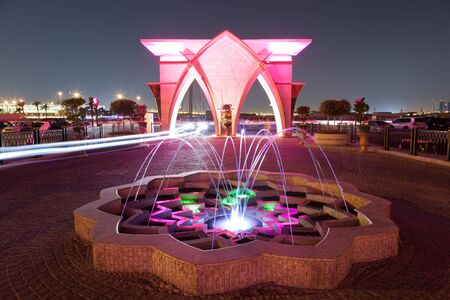 DOHA, QATAR - NOV 19: Colorful illuminated fountain and gate at the corniche of Doha. November 19, 2015 in Doha, Qatar, Middle Eastのeditorial素材