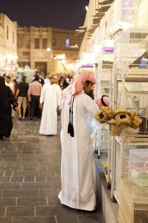 DOHA, QATAR - NOV 19: Qatari man shopping at the traditional market Souq Waqif. November 19, 2015 in Doha, Qatar, Middle Eastのeditorial素材