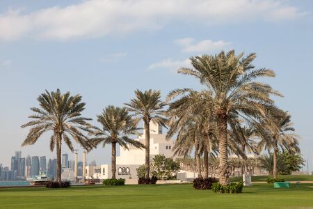 DOHA, QATAR - NOV 21: Palm Trees and Museum of Islamic Arts at the corniche of Doha. November 21, 2015 in Doha, Qatar, Middle Eastのeditorial素材