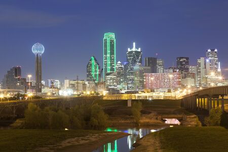 Dallas downtown skyline illuminated at night with reflection in the Trinity River. Texas, United Statesの写真素材