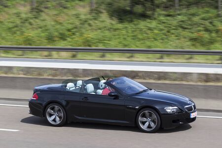 FRANKFURT, GERMANY - JULY 12, 2016: Black BMW M6 Convertible on the highway in Germanyのeditorial素材