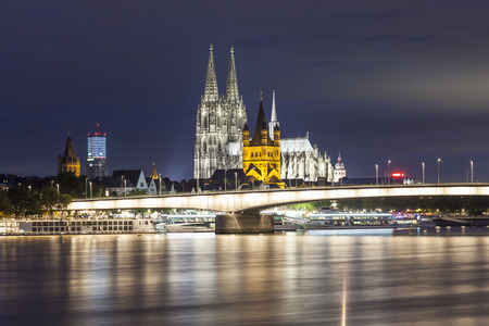 Cologne Cathedral and the Great Saint Martin Church in Cologne illuminated at night. North Rhine-Westphalia, Germanyのeditorial素材