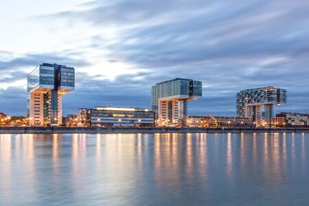 COLOGNE, GERMANY - AUG 7, 2016: The three Crane Houses at the Rhine river in Cologne illuminated at dusk. North Rhine-Westphalia, Germanyのeditorial素材