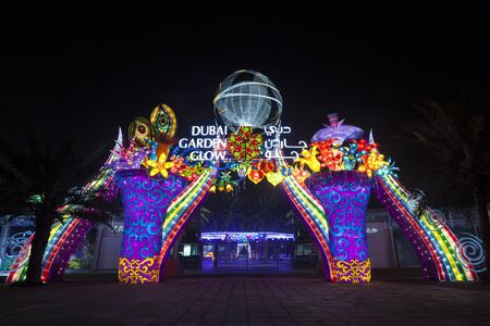 DUBAI, UAE - DEC 6, 2016: Entrance gate to the Dubai Garden Glow family theme park illuminated at night. United Arab Emirates, Middle Eastのeditorial素材