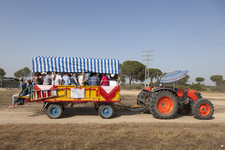 El Rocio, Spain - June 1, 2017: Pilgrims in a tractor drawn trailer on the road to El Rocio during the pilgrimage Romeria 2017. Province of Huelva, Almonte, Spainのeditorial素材