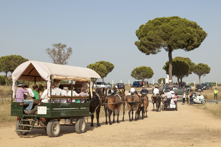 El Rocio, Spain - June 1, 2017: Pilgrims in a horse-drawn carriage on the road to El Rocio during the Romeria 2017. Province of Huelva, Almonte, Andalusia, Spainのeditorial素材