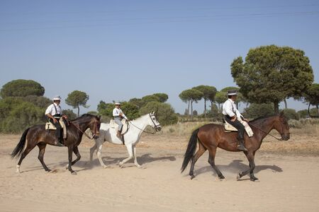 El Rocio, Spain - June 1, 2017: Pilgrims on horseback in  traditional spanish dress on the road to El Rocio during the Romeria 2017. Province of Huelva, Almonte, Andalusia, Spainのeditorial素材