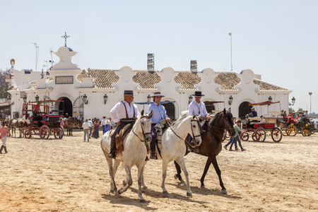 El Rocio, Spain - June 2, 2017: Group of pilgrims on horseback in  traditional spanish dress in El Rocio during the Romeria 2017. Province of Huelva, Almonte, Andalusia, Spainのeditorial素材