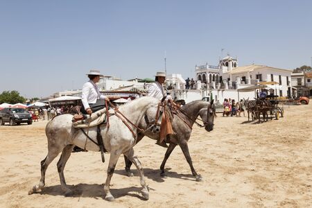 El Rocio, Spain - June 2, 2017: Group of pilgrims on horseback in  traditional spanish dress in El Rocio during the Romeria 2017. Province of Huelva, Almonte, Andalusia, Spainのeditorial素材