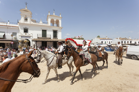 El Rocio, Spain - June 2, 2017: Pilgrims on horseback in  traditional spanish dress in El Rocio during the Romeria 2017. Province of Huelva, Almonte, Andalusia, Spainのeditorial素材