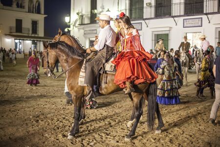 El Rocio, Spain - June 4, 2017: Group of pilgrims on horseback in  traditional spanish dress in El Rocio during the Romeria 2017. Province of Huelva, Almonte, Andalusia, Spainのeditorial素材