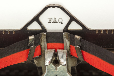 Close up image of a vintage typewriter with paper sheet and the phrase: FAQ. Copy space for your textの写真素材