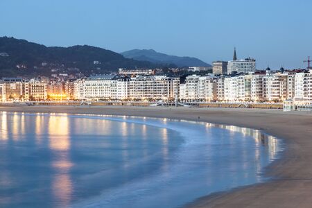 Waterfront buildings in San Sebastian illuminated at night. Basque country, Spainの写真素材