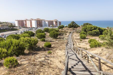 Wooden walkway at a sand dune at the atlantic coast in Matalascanas. Costa de la Luz, Andalusia, Spainの写真素材