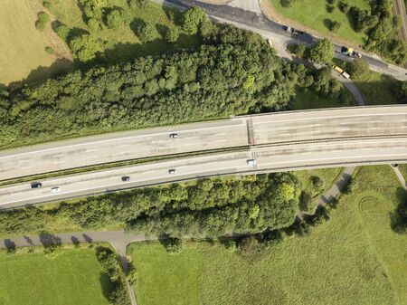 Aerial view of a german autobahn surrounded by forest and green fields