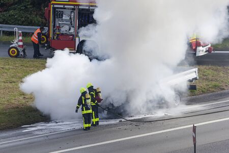 Frankfurt, Germany - Sep 19, 2017: Burning truck on the highway in germany. Firemen extinguish the...
