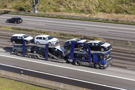 Frankfurt, Germany - Sep 19, 2017: Scania P410 car transporter hauls new Volkswagen Golf cars along the A45 highway in Germanyのeditorial素材
