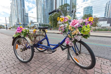 Classic tricycle or trike with flowers in the city の写真素材