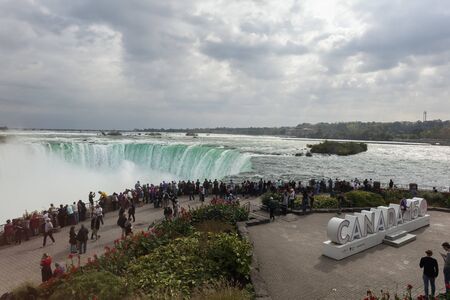 Niagara Falls, Canada - Oct 15, 2017: Tourists at the viewing platform at the Niagara Falls. Province of Ontario, Canadaのeditorial素材