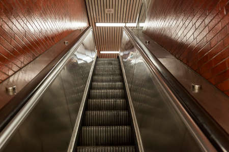 Escalator moving up stairs in a metro stationの写真素材